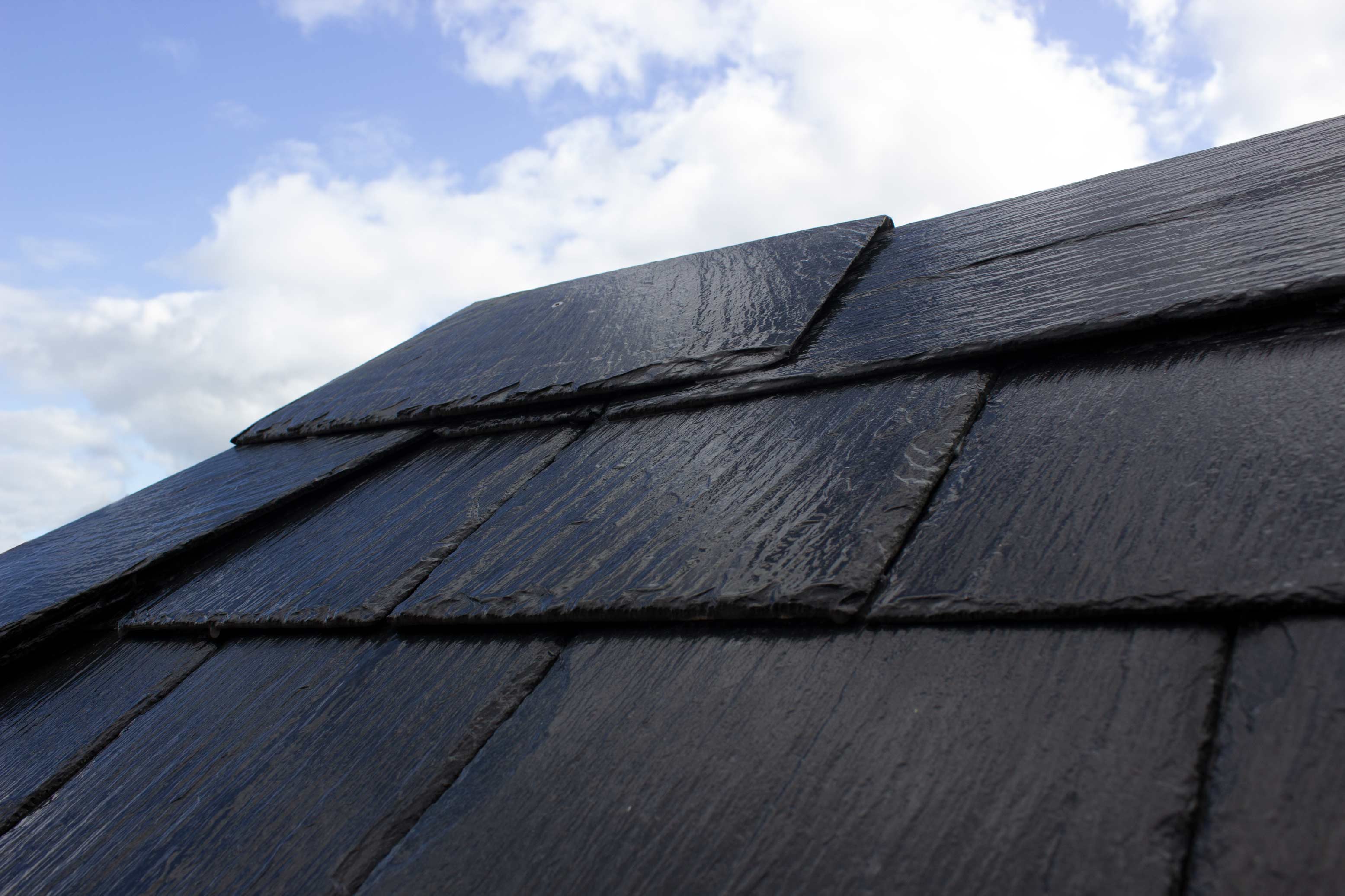 Ridge capping to the hip with our pre-formed slate ridge hip cap. 